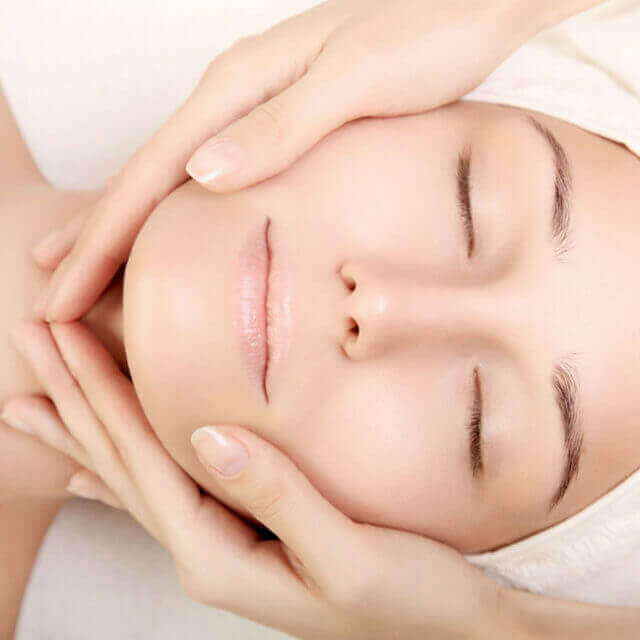 Woman relaxing during a facial treatment, one of the skin services offered by 7 Derma Center