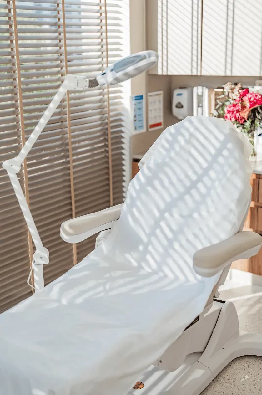 White treatment chair in a sunlit procedure room at Seline Clinic