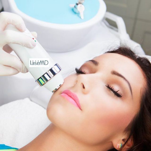 Woman receiving a LaseMD laser skin treatment on her face at 7 Derma Center