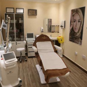 Treatment room at 7 Derma Center in Jumeirah, Dubai, with a treatment bed and laser machines
